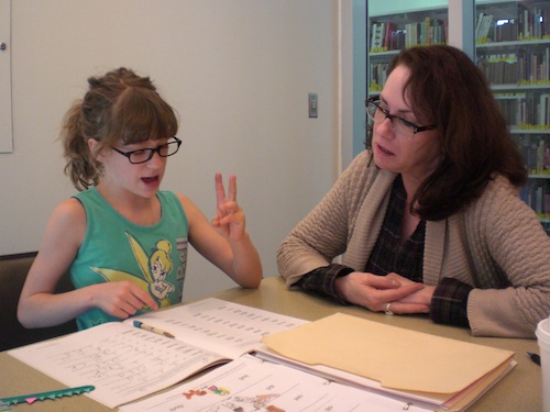 Working with a student at the library