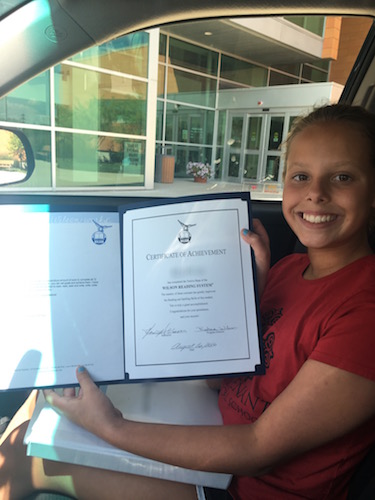 A successful student with her certificate